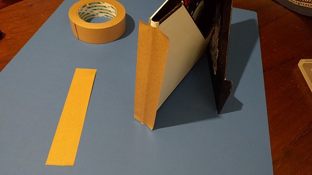 Framer's tape to reinforce the wings of the Grimoire stand base. — Photo by nosewhoknows on BoardGameGeek