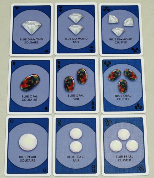 a grid of nine cards featuring blue diamonds, blue pearls, and blue opals