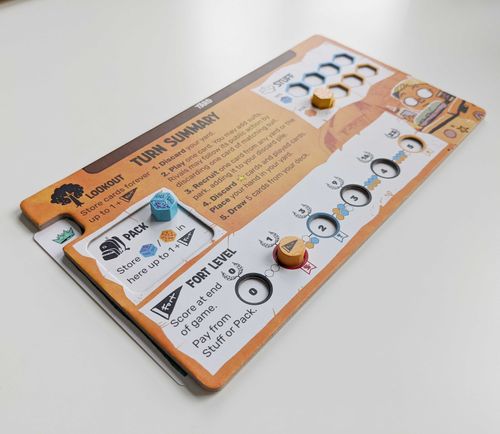 Orange player board with toy token and fort tracking token