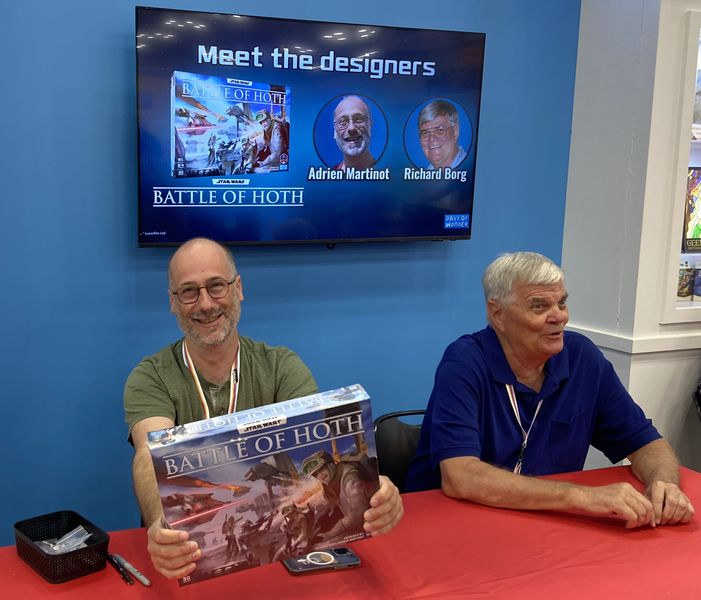 Designers Adrien Martinot and Richard Borg sign copies and answer questions at Gen Con 2025