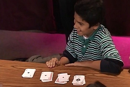 kid performing card tricks