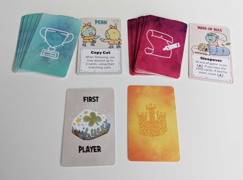 A selection of smaller "perk" cards, made up rule cards, and the first player token