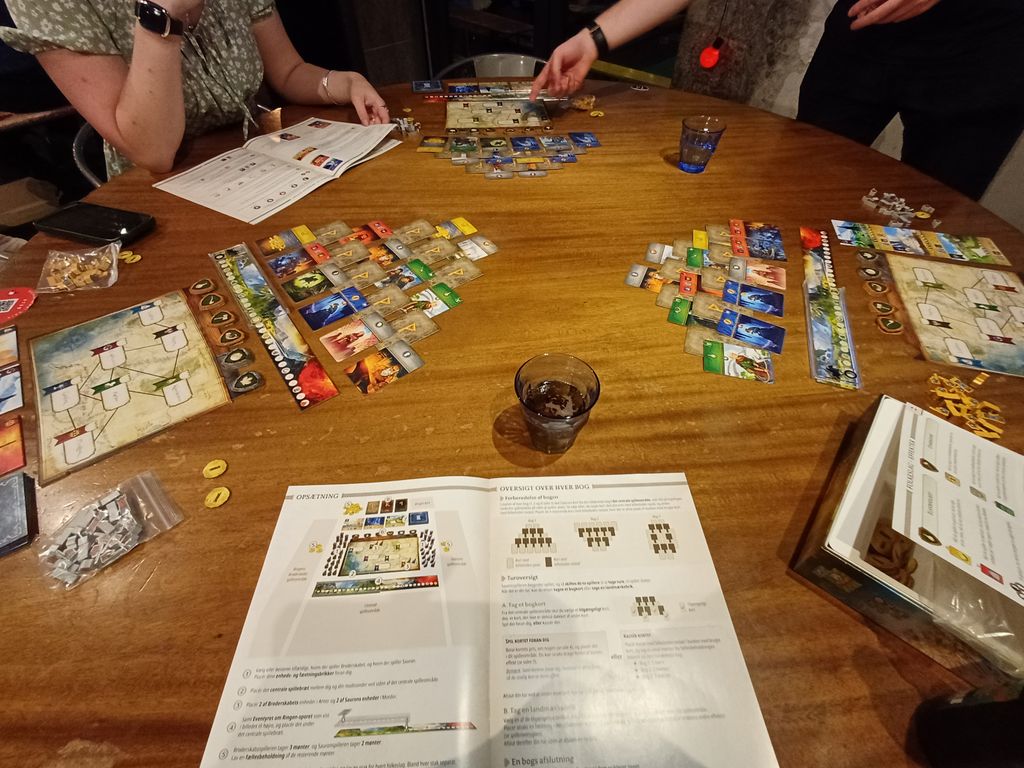 Mikołaj, Thea and I all wanted to play our first game. Since we were 3, we took a copy each to play as Sauron against the person to our left, meaning we were also simultaneously playing a second game as the free alliance against the person to our right. — Photo by Strategette on BoardGameGeek